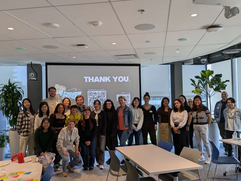 Group photo of attendees in front of a thank-you slide at The Side-Hustle Blueprint for Designers